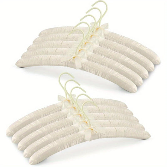 Luxury satin coat hangers in pale cream, ideal for bridal parties or adding elegance to wardrobes.