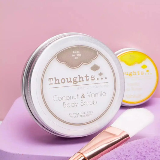 Coconut & Vanilla Body Scrub in jar with brush, exfoliating and moisturizing.
