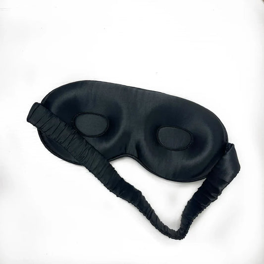 Contoured Silk Sleep Mask in black with elastic strap for enhanced comfort and lash protection.