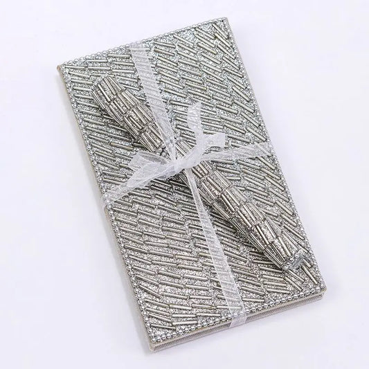 Silver Tubes Notebook and pen set wrapped with ribbon.