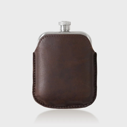 Stainless steel hip flask with brown leather sleeve.