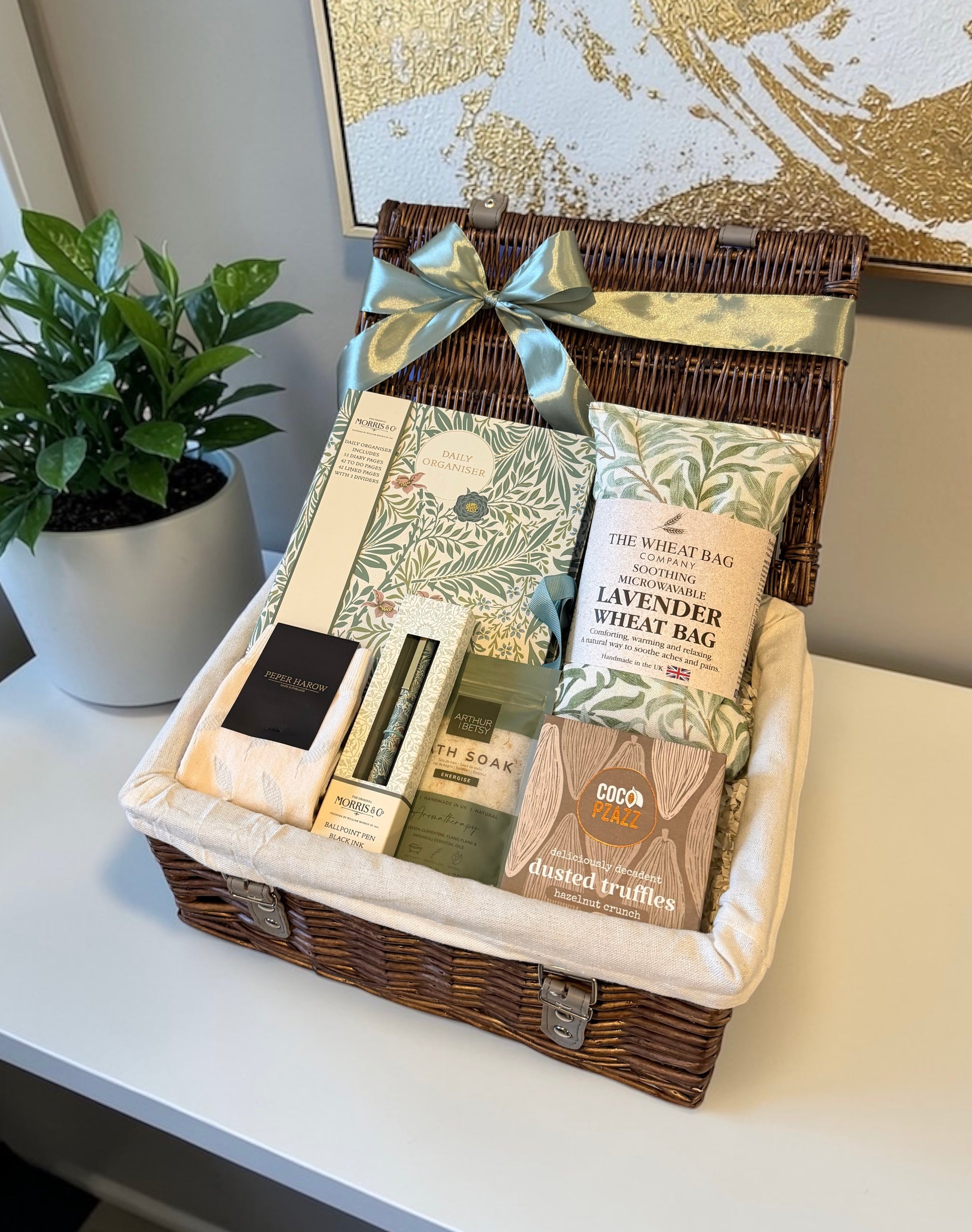 Wellbeing hamper with William Morris cotton wheat bag, truffles, Peper Harow socks, bath salts, organiser and pen in gift box.