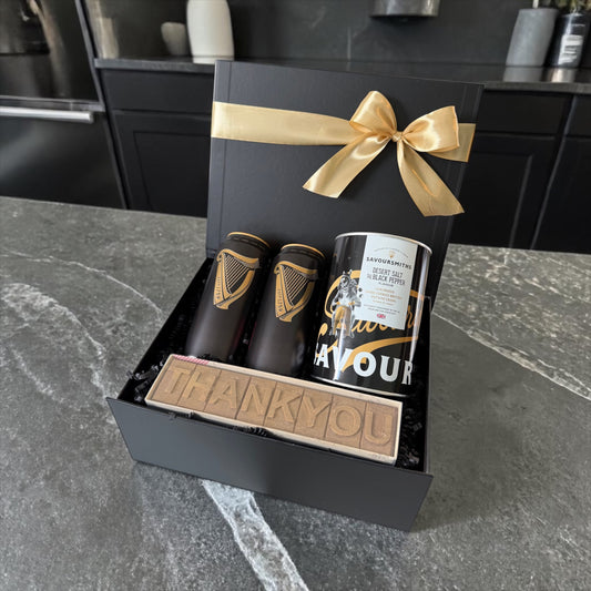 Black gift box with beer, gourmet crisps and thank you chocolate bar tied with gold ribbon