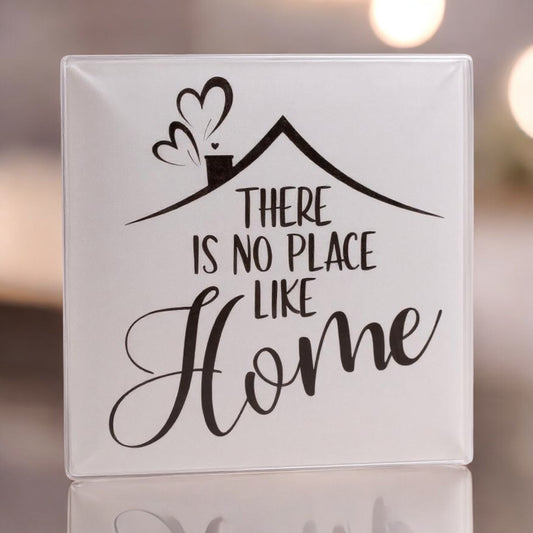 Decorative glass tile with 'There is no place like home' text and house illustration.