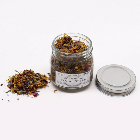 Calming botanical facial steam blend with lavender, rose, chamomile, and calendula petals in a glass jar.