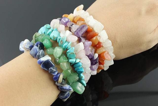 Opalite gemstone chip bracelet showcasing a variety of colorful gemstones on a wrist.