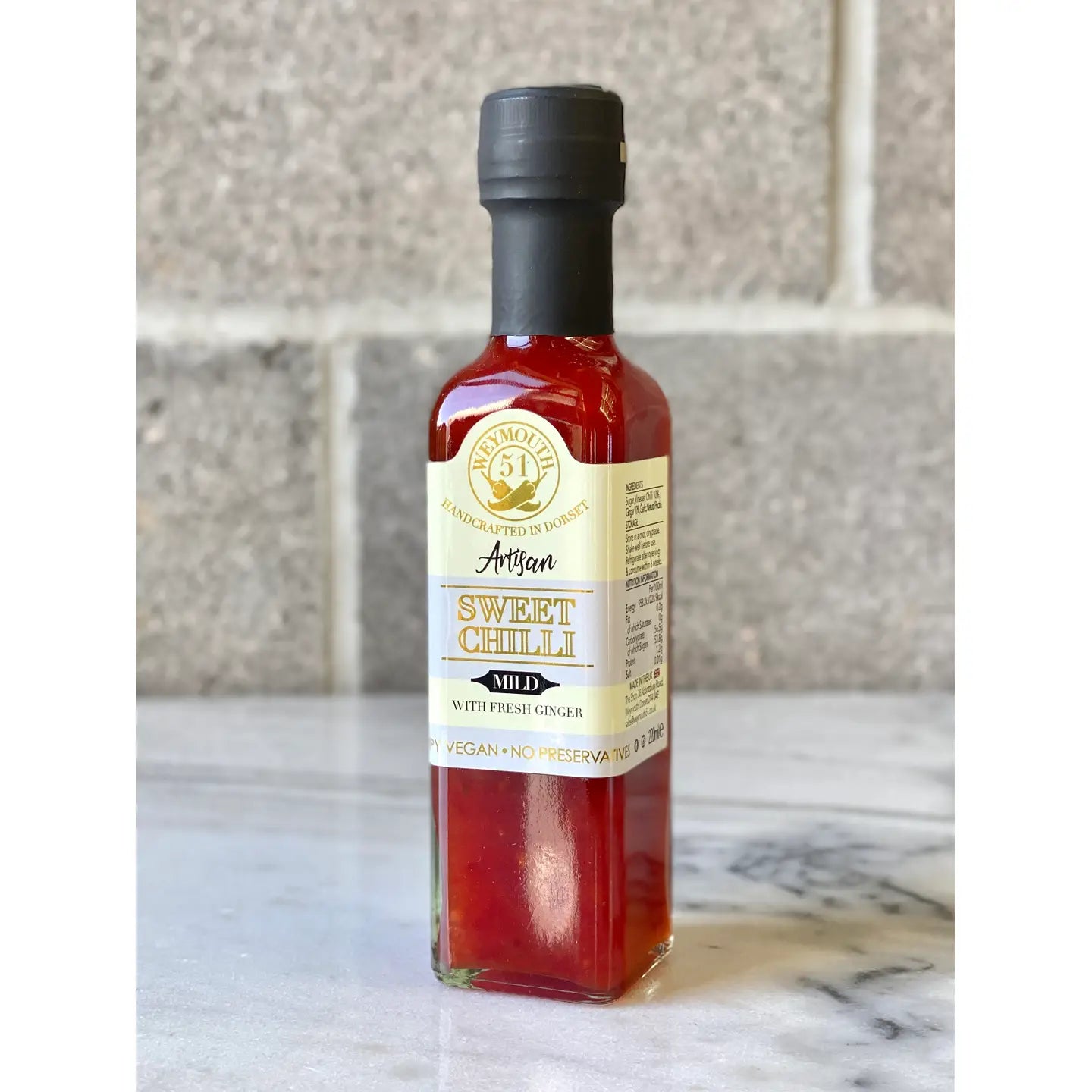 Mild Vegan Sweet Chilli Sauce with ginger and apple cider vinegar in a glass bottle.
