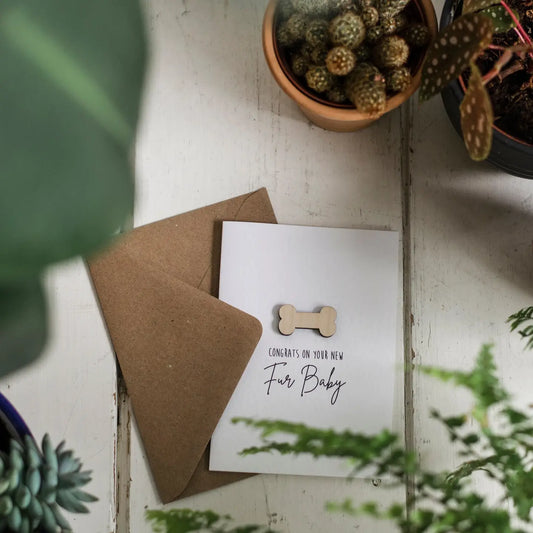 Luxury Wooden Congrats On Your New Fur Baby Card on table with plants.