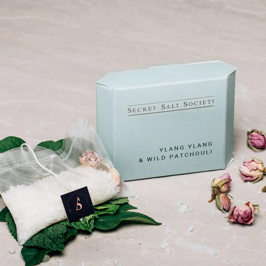 Fragrant Ylang Ylang and Wild Patchouli Mineral Bath Infusion with packaging.